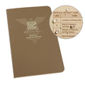 A brown, weatherproof notebook with a logo and text on the cover, titled 'MEDIC FIELD BOOK - RITE IN RAIN'. It shows an example of water drops on the paper